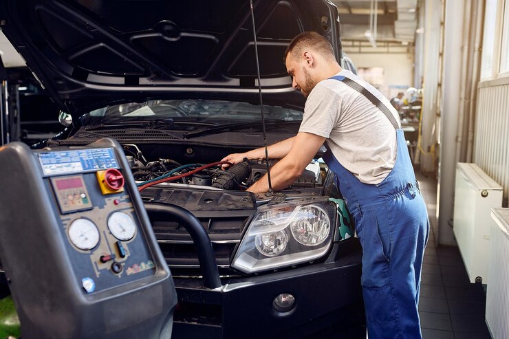 refueling-air-conditioner-mechanic-pumps-freon-into-air-conditioning-system-car-service